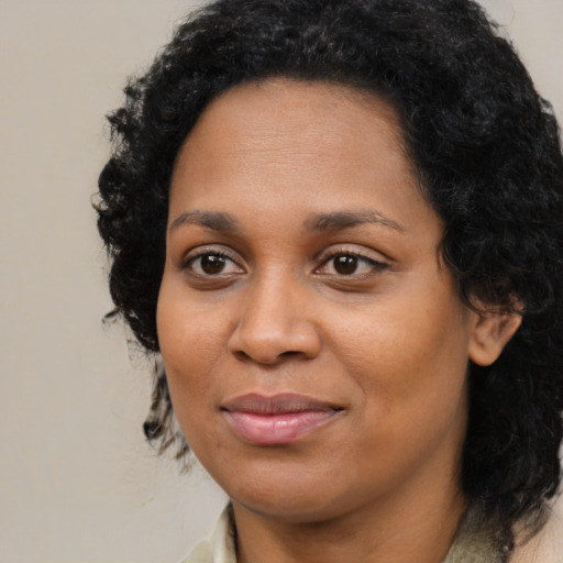 Joyful black young-adult female with medium  brown hair and brown eyes