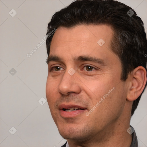 Joyful white adult male with short  black hair and brown eyes