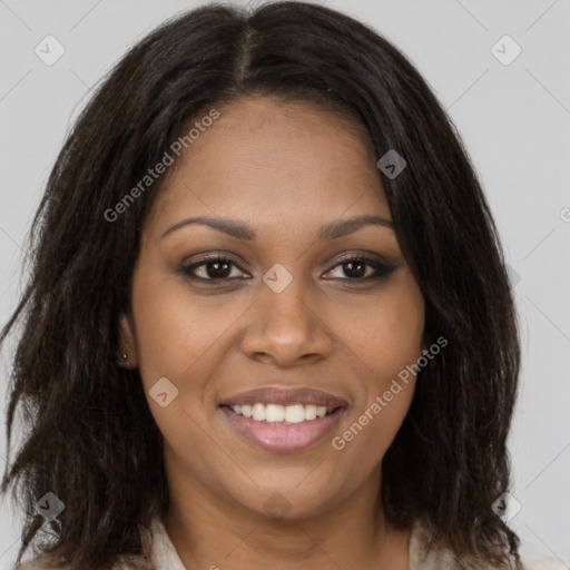 Joyful black young-adult female with long  brown hair and brown eyes