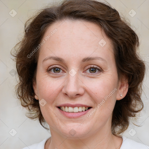 Joyful white adult female with medium  brown hair and green eyes