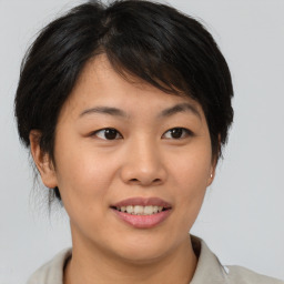 Joyful asian young-adult female with medium  brown hair and brown eyes