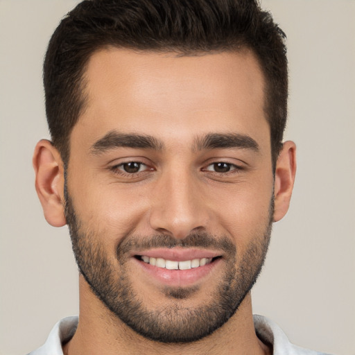 Joyful white young-adult male with short  brown hair and brown eyes