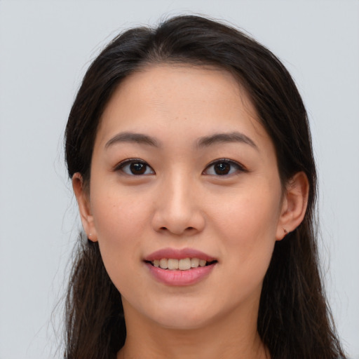 Joyful asian young-adult female with long  brown hair and brown eyes