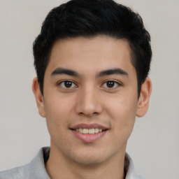 Joyful latino young-adult male with short  brown hair and brown eyes