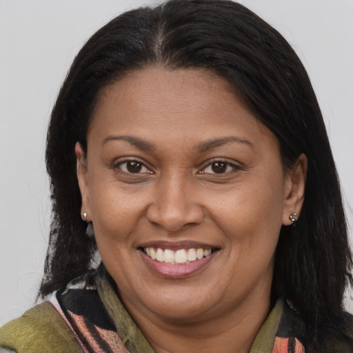 Joyful latino adult female with medium  brown hair and brown eyes