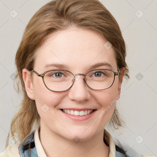 Joyful white adult female with medium  brown hair and blue eyes