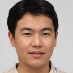 Joyful asian young-adult male with short  brown hair and brown eyes