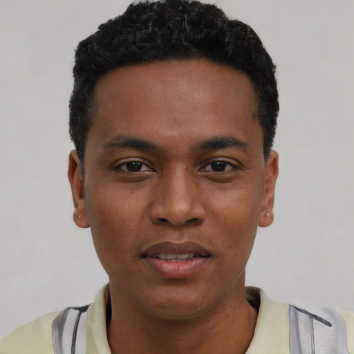 Joyful black young-adult male with short  black hair and brown eyes