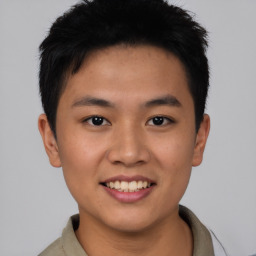 Joyful asian young-adult male with short  brown hair and brown eyes