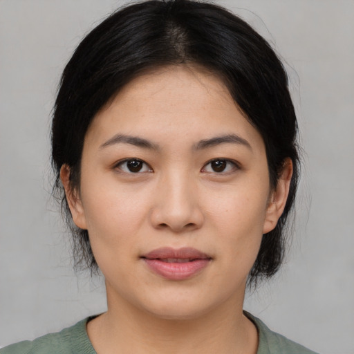 Joyful asian young-adult female with medium  black hair and brown eyes