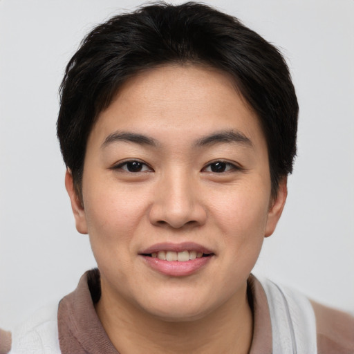 Joyful asian young-adult female with short  brown hair and brown eyes