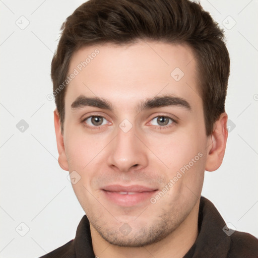 Joyful white young-adult male with short  brown hair and brown eyes