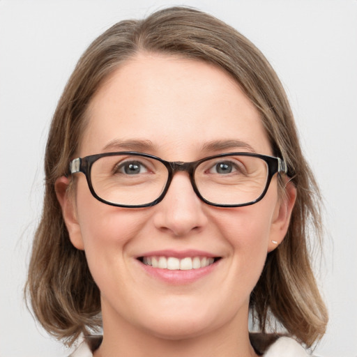 Joyful white young-adult female with medium  brown hair and blue eyes