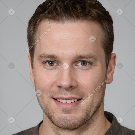 Joyful white young-adult male with short  brown hair and grey eyes