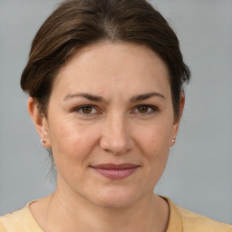 Joyful white adult female with short  brown hair and brown eyes