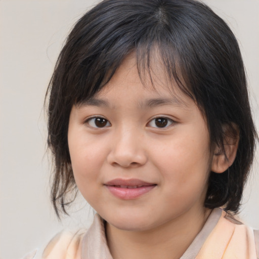 Joyful asian child female with medium  brown hair and brown eyes