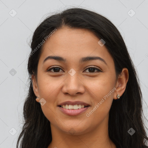 Joyful latino young-adult female with long  brown hair and brown eyes