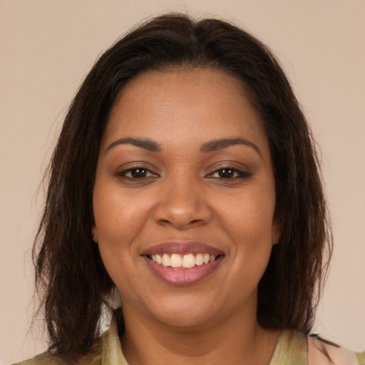 Joyful latino young-adult female with medium  brown hair and brown eyes