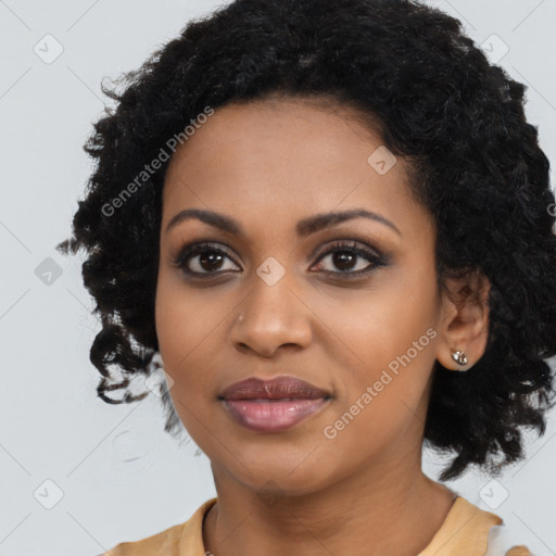 Joyful black young-adult female with long  black hair and brown eyes