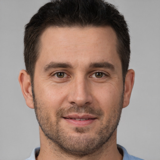 Joyful white adult male with short  brown hair and brown eyes