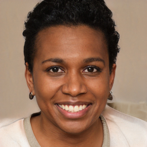 Joyful black young-adult female with short  brown hair and brown eyes