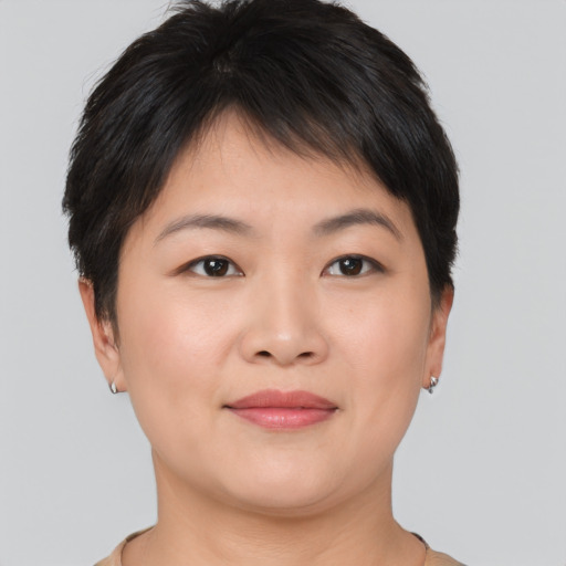 Joyful asian young-adult female with short  brown hair and brown eyes