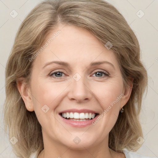 Joyful white adult female with medium  brown hair and grey eyes