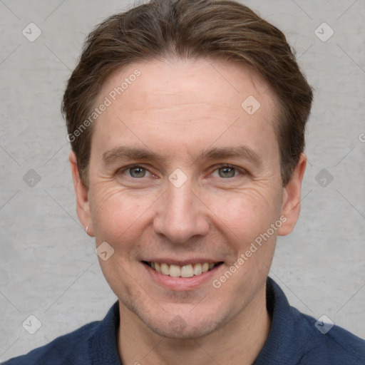 Joyful white adult male with short  brown hair and grey eyes