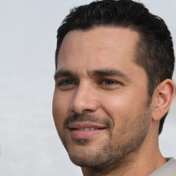 Joyful white young-adult male with short  black hair and brown eyes