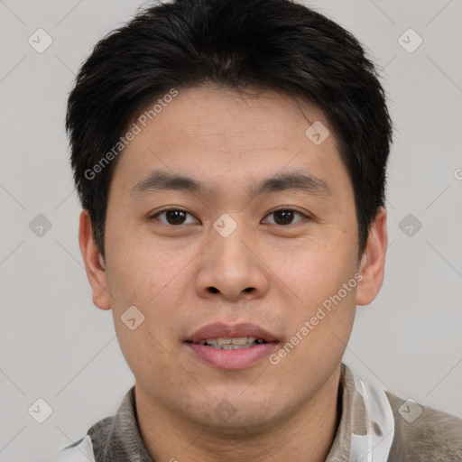 Joyful asian young-adult male with short  brown hair and brown eyes