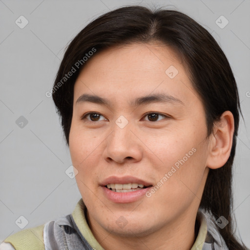 Joyful asian young-adult male with short  brown hair and brown eyes