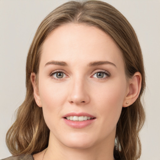 Joyful white young-adult female with medium  brown hair and green eyes