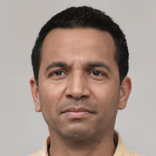 Neutral latino adult male with short  black hair and brown eyes