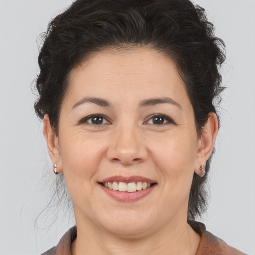 Joyful white adult female with medium  brown hair and brown eyes