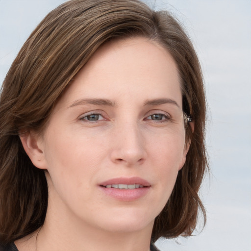 Joyful white young-adult female with medium  brown hair and blue eyes