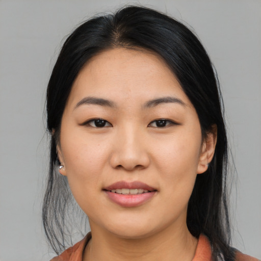 Joyful asian young-adult female with medium  black hair and brown eyes
