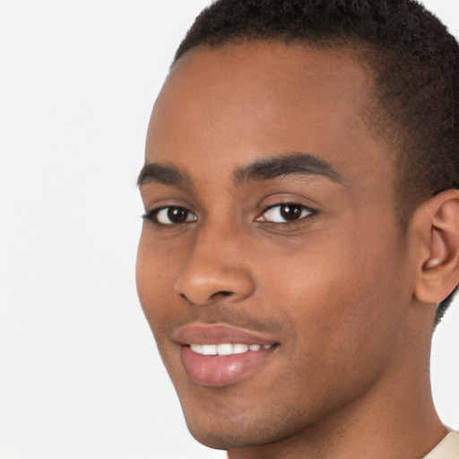 Joyful black young-adult male with short  brown hair and brown eyes