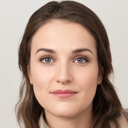 Joyful white young-adult female with long  brown hair and grey eyes