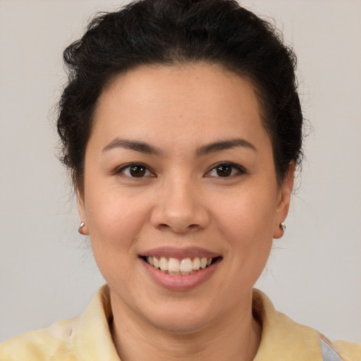 Joyful latino young-adult female with short  brown hair and brown eyes