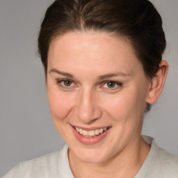 Joyful white adult female with medium  brown hair and brown eyes