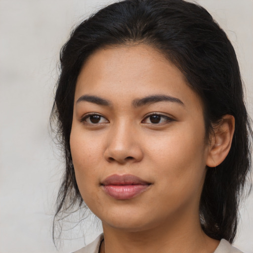 Joyful asian young-adult female with medium  brown hair and brown eyes