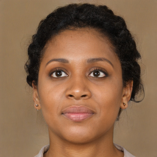 Joyful black young-adult female with short  brown hair and brown eyes