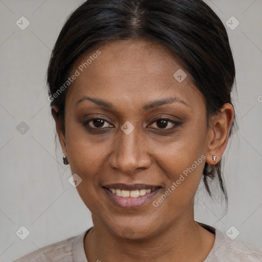 Joyful black adult female with medium  brown hair and brown eyes