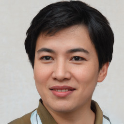 Joyful asian young-adult male with short  brown hair and brown eyes