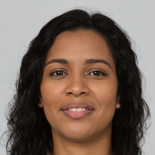 Joyful latino young-adult female with long  brown hair and brown eyes