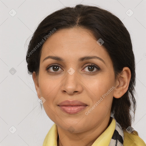 Joyful latino adult female with medium  brown hair and brown eyes