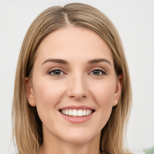 Joyful white young-adult female with long  brown hair and green eyes