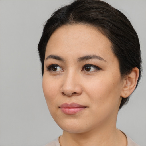 Joyful asian young-adult female with medium  brown hair and brown eyes