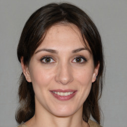 Joyful white young-adult female with medium  brown hair and brown eyes