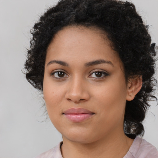 Joyful latino young-adult female with medium  black hair and brown eyes